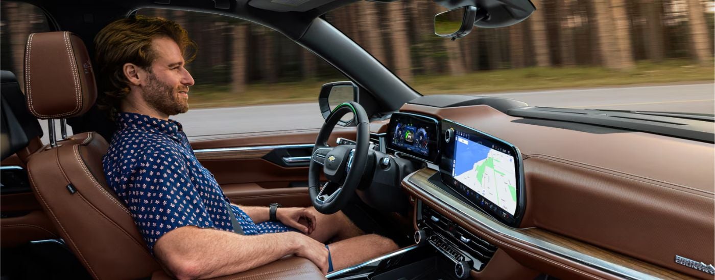 Interior view of a 2026 Chevy Suburban High Country with a person driving.