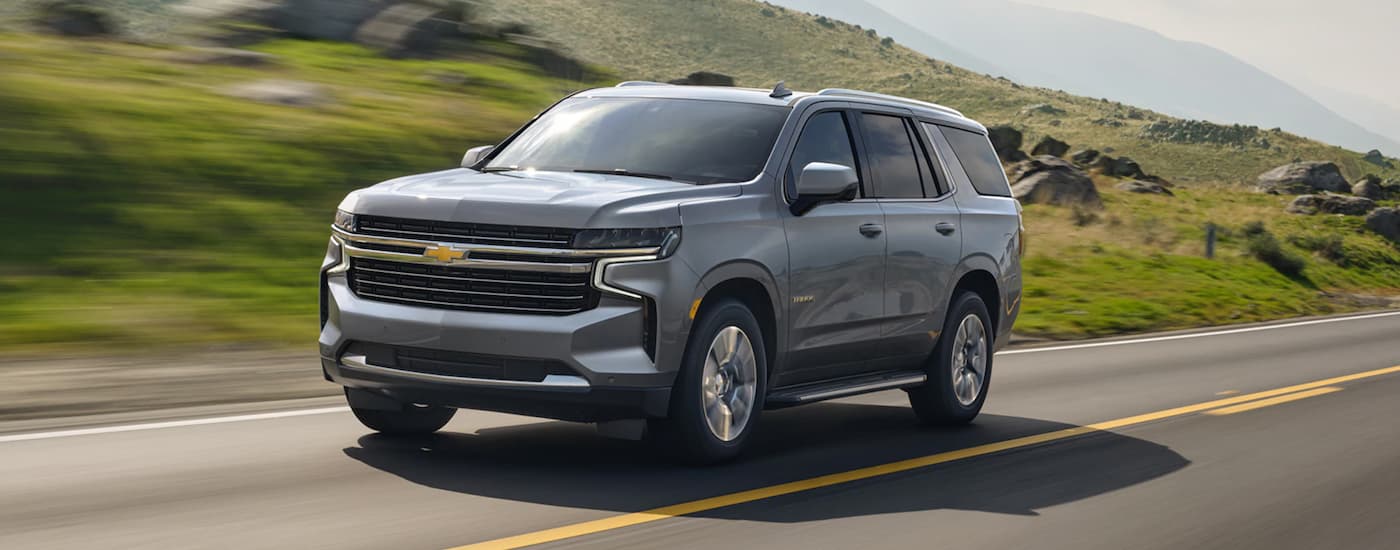Silver 2021 Chevy Tahoe driving on an open road
