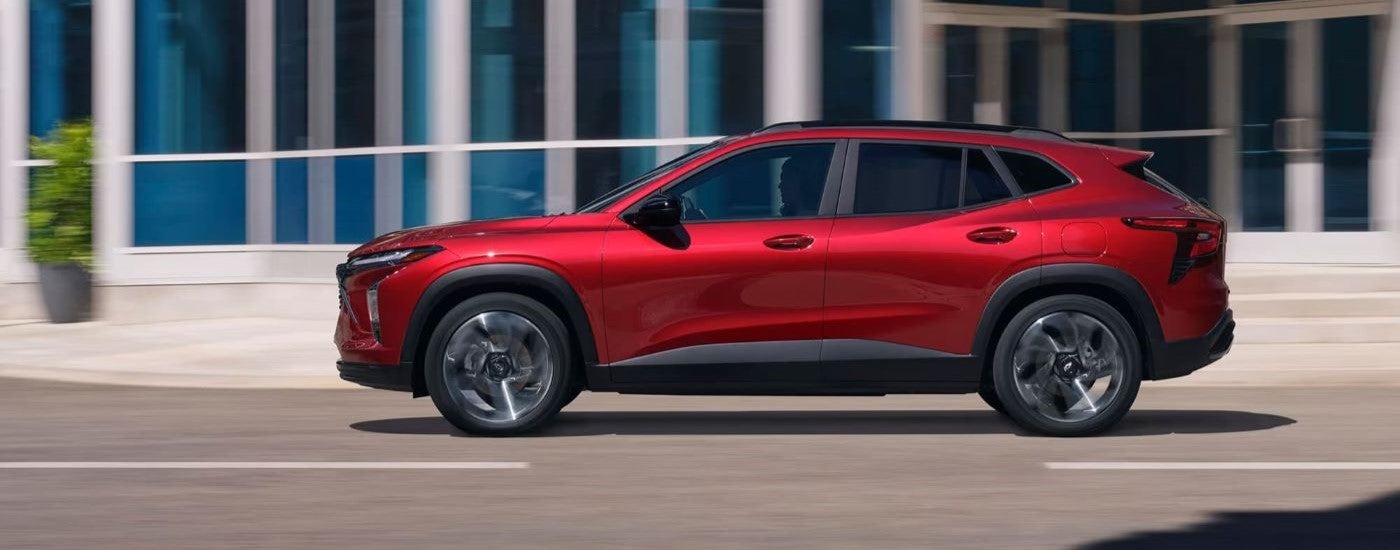 Red 2024 Chevy Trax RS driving through a city