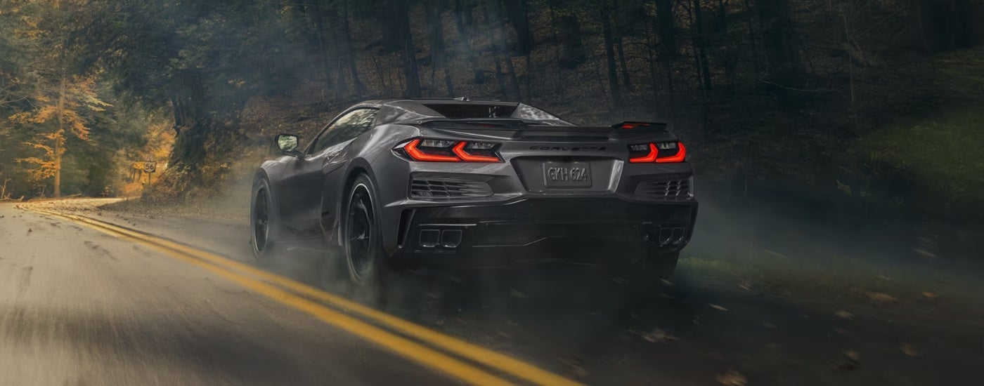 Grey 2025 Chevy Corvette E-Ray dricing to a used Chevy dealer