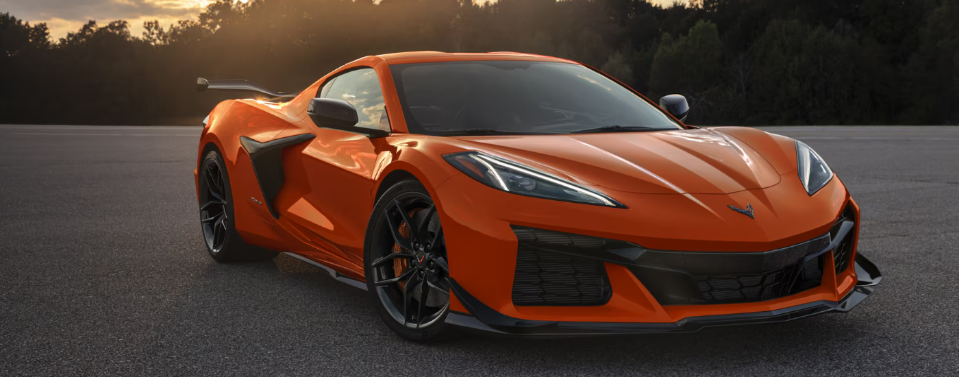 Orange 2026 Chevy Corvette Z06 parked at an angle at dusk