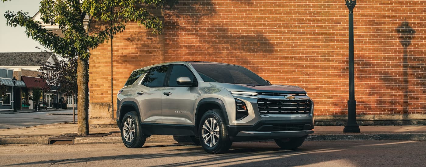 Grey 2026 Chevy Equinox parked in front of a brick wall