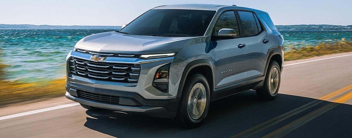 Silver 2026 Chevy Equinox driving along the coast