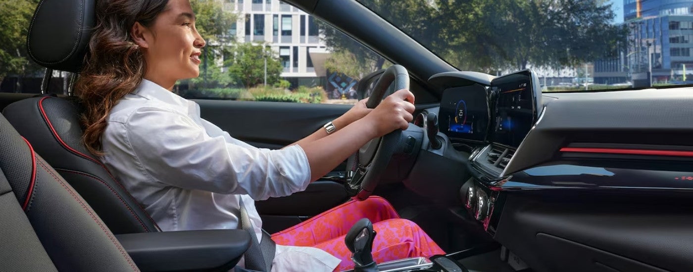 A woman driving a 2026 Chevy Trax.