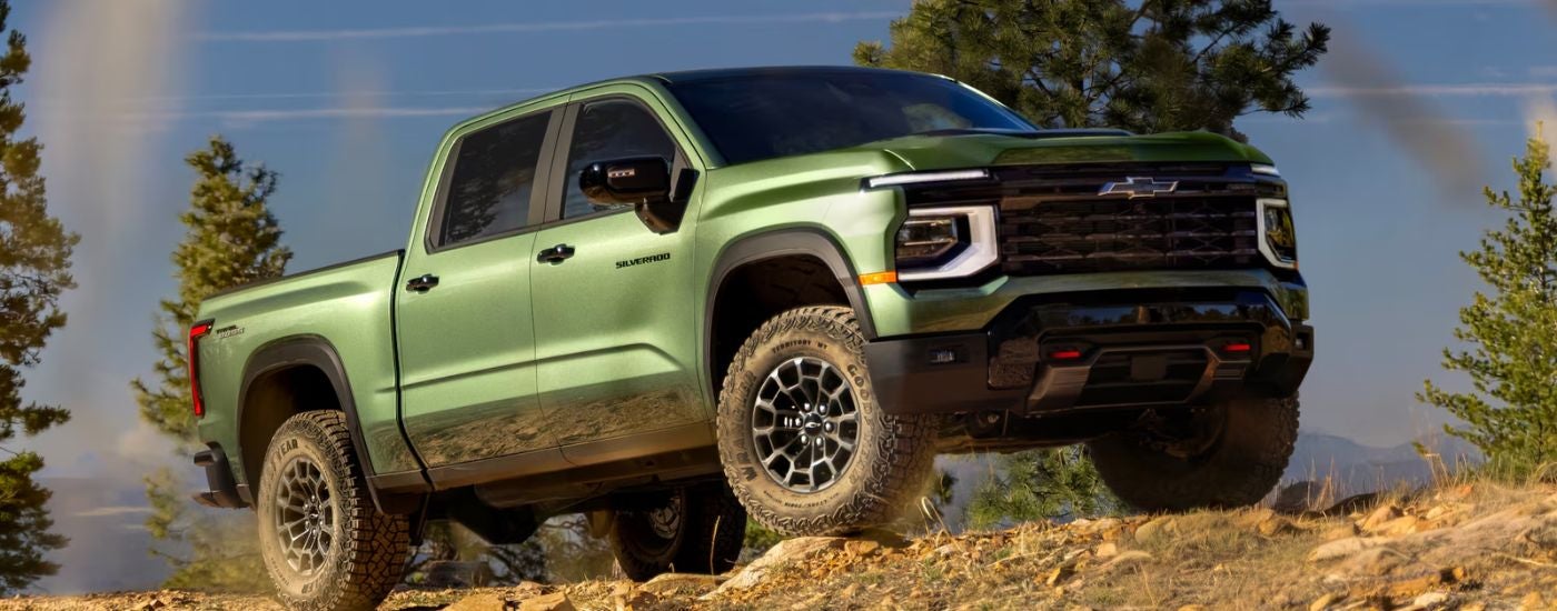 Green 2027 Chevy Silverado 1700 parked off-road at an angle