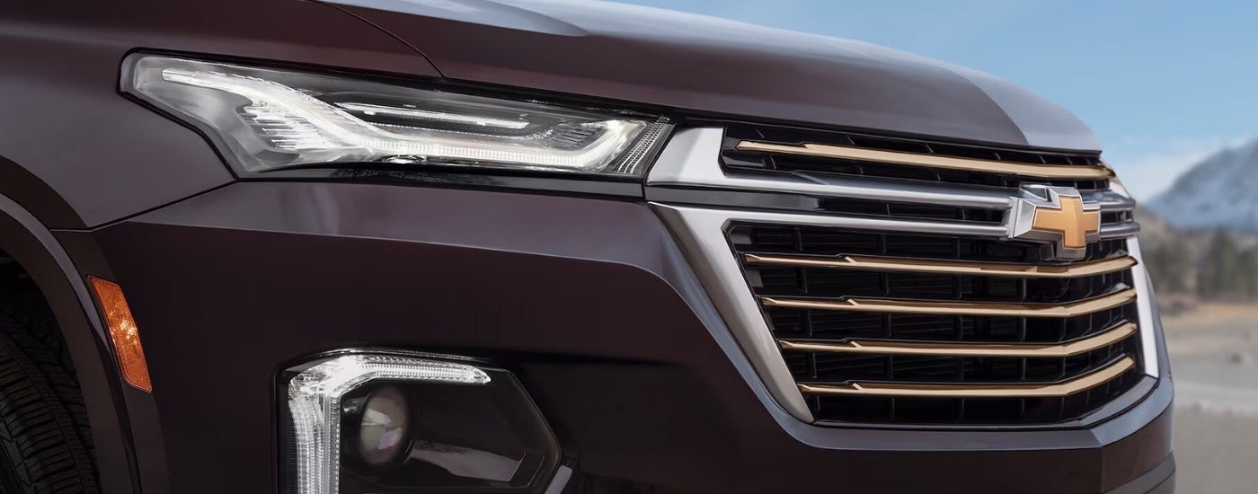 Front grille of a maroon 2022 Chevy Traverse.